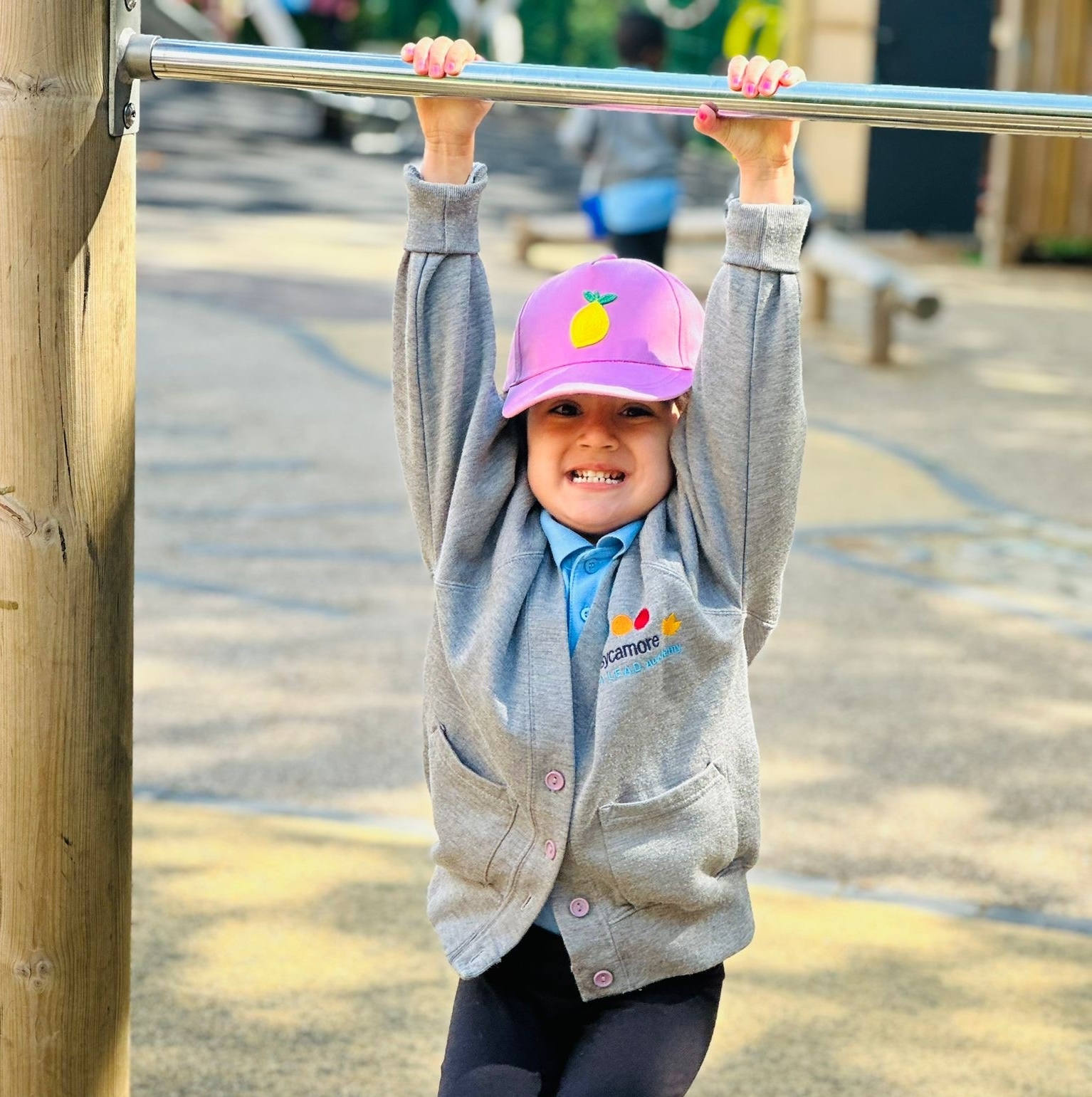 Sycamore Nursery child on climbing frame bar