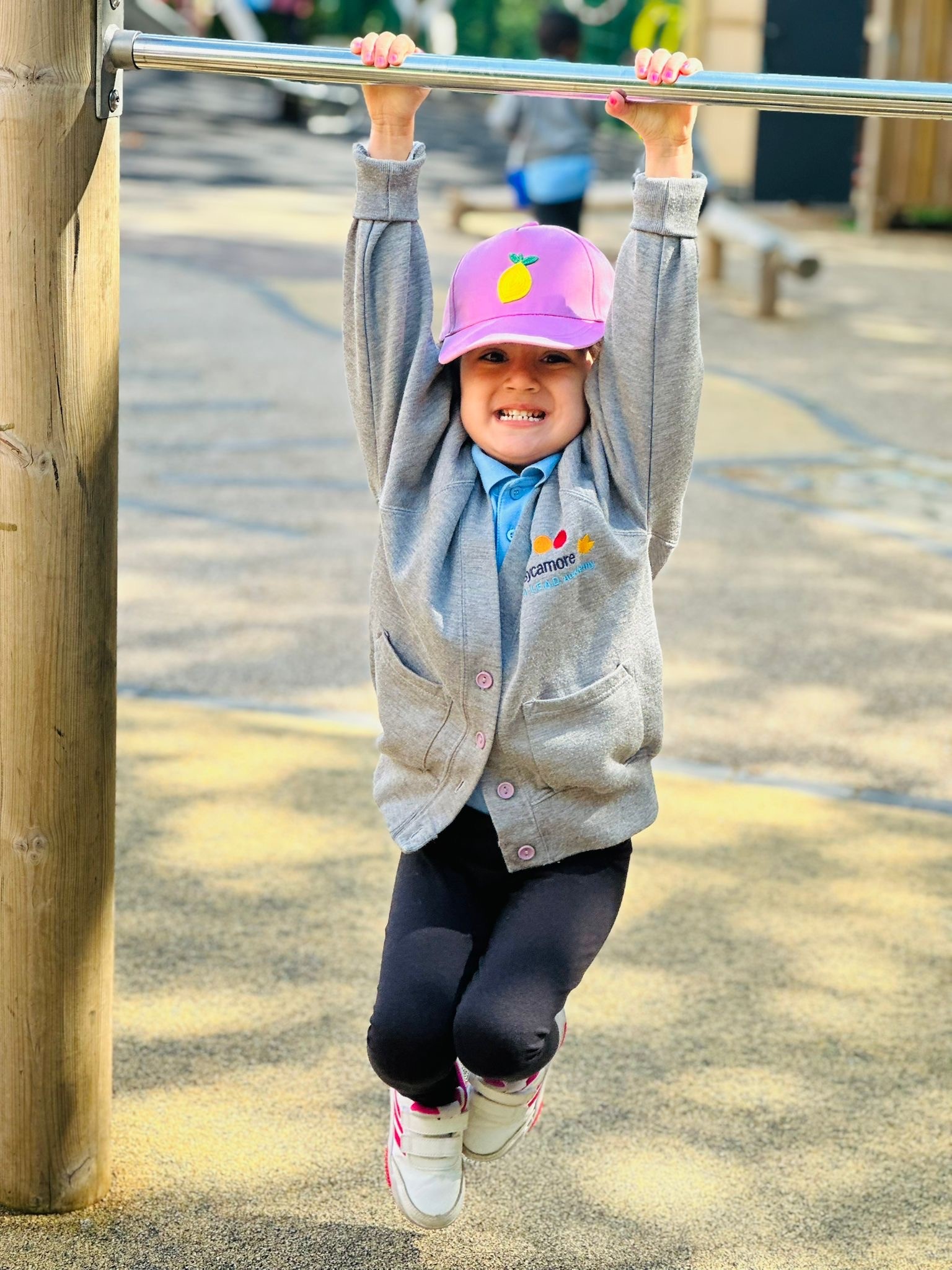 Sycamore Nursery child on climbing frame bar