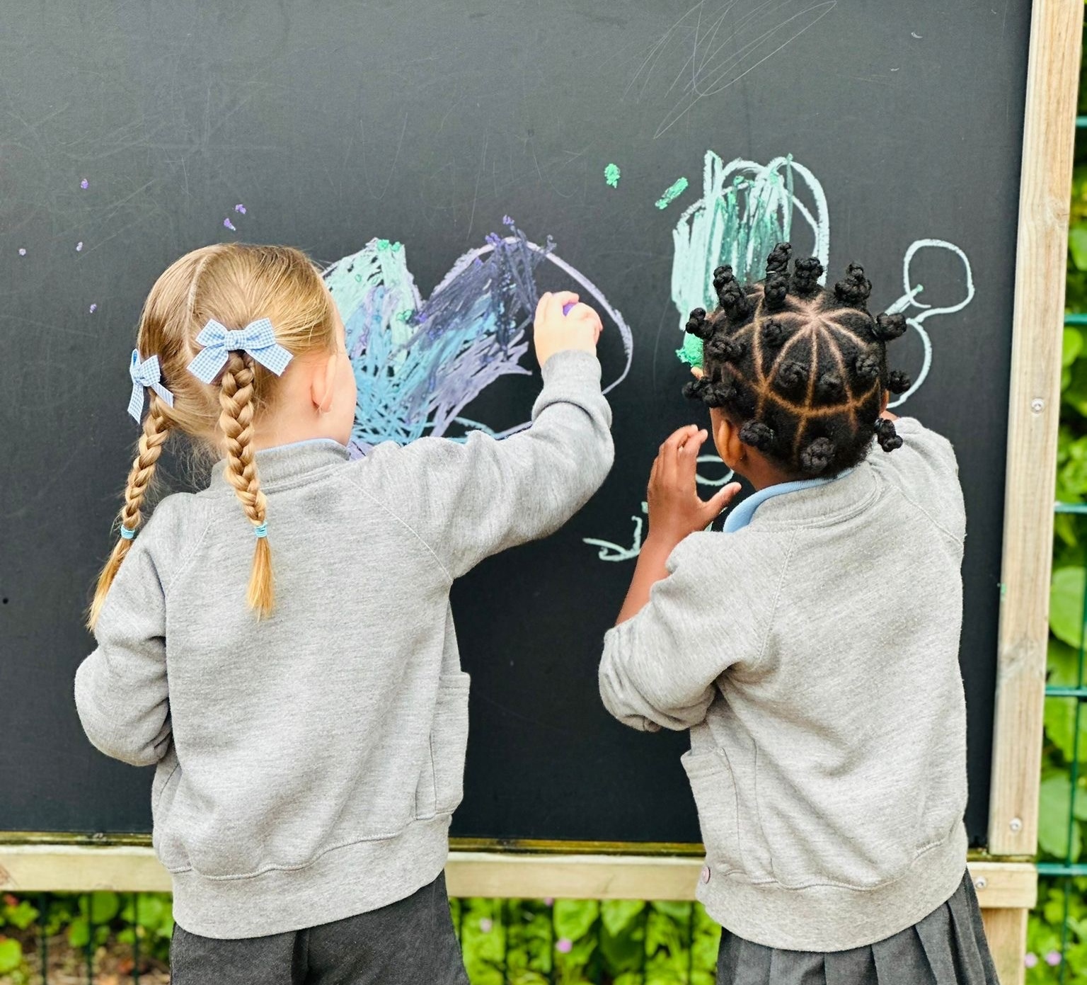 Sycamore Nursery children with chalk board