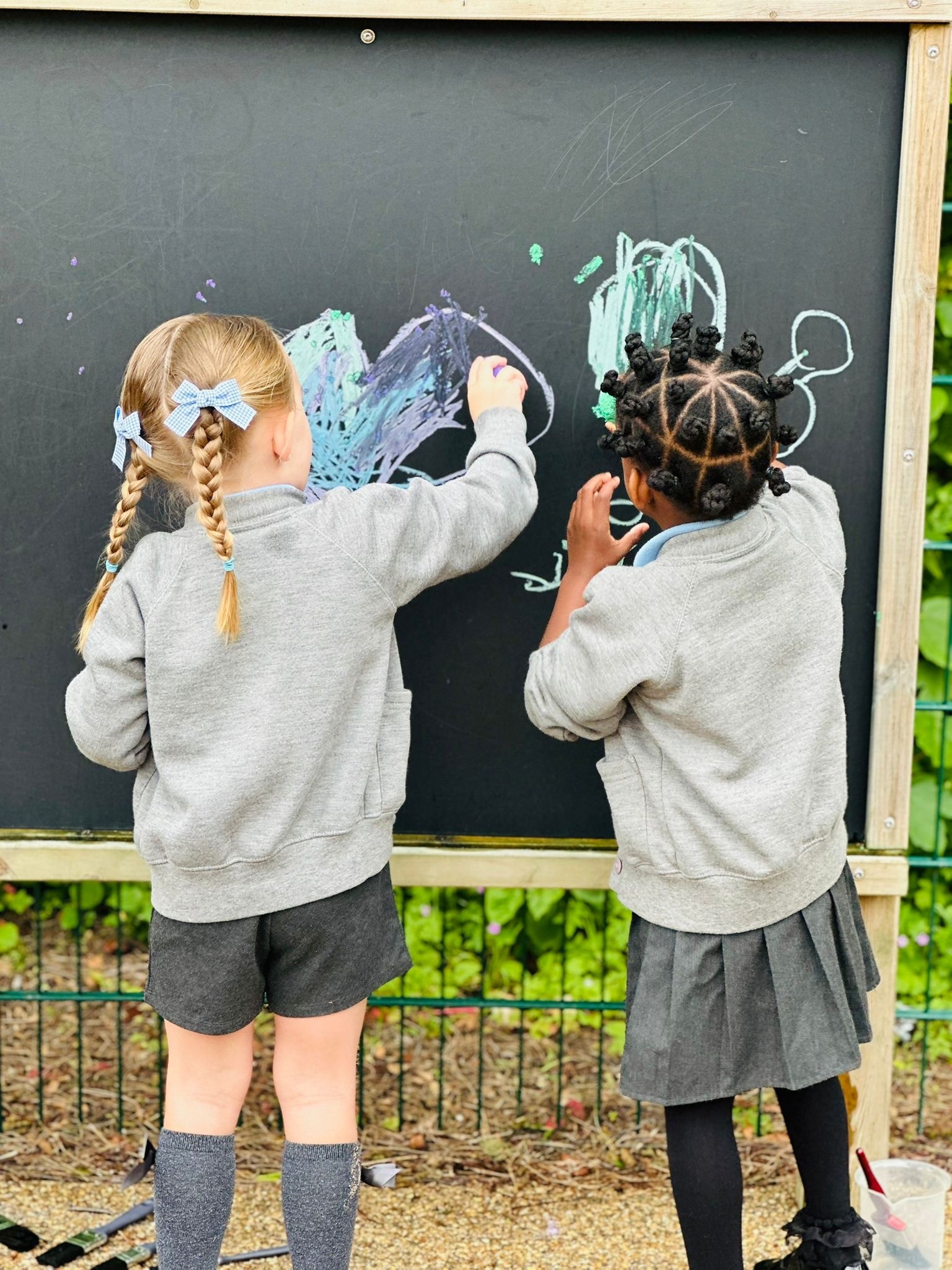 Sycamore Nursery children with chalk board