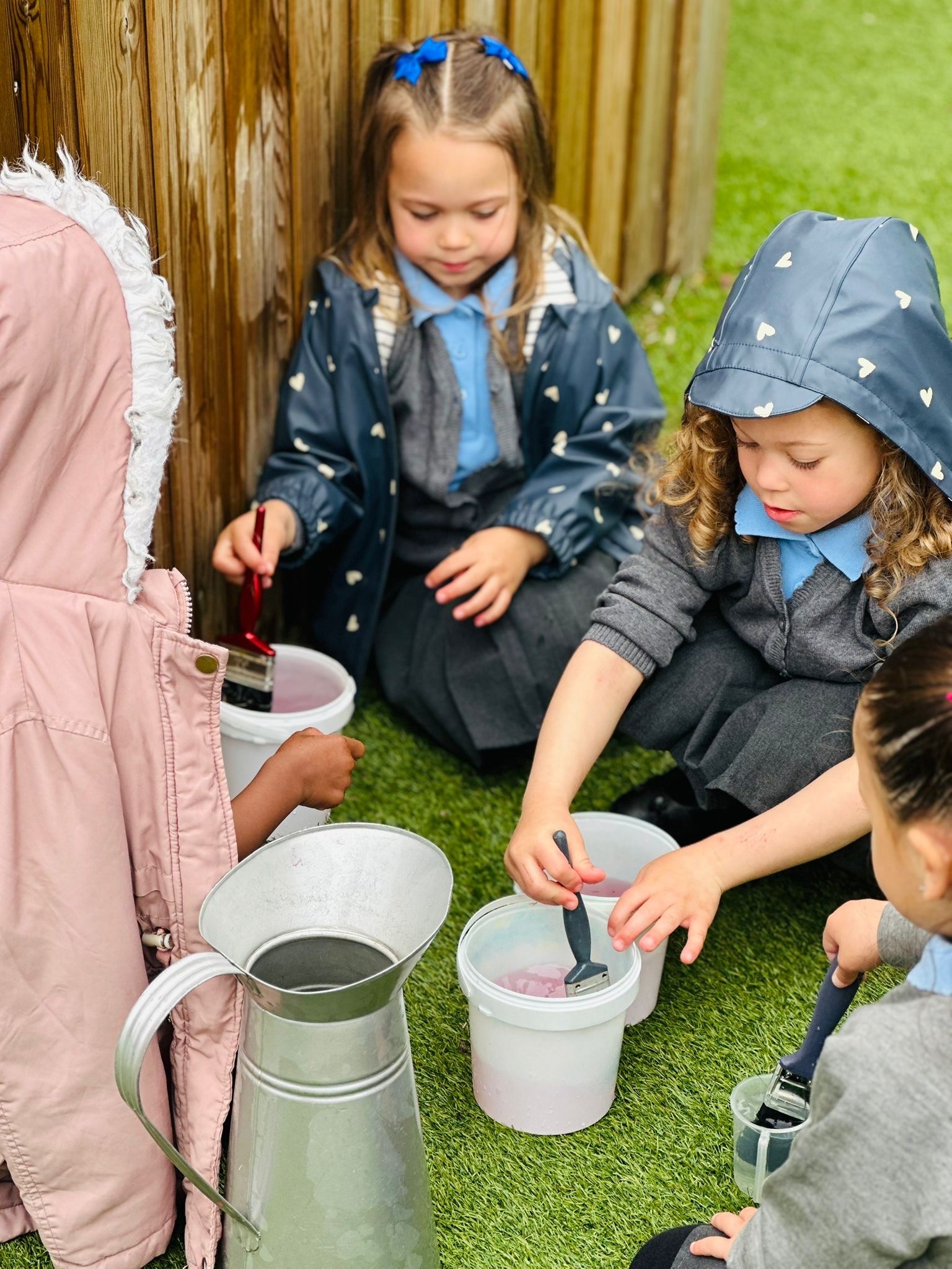 Sycamore Nursery children with paint brushes