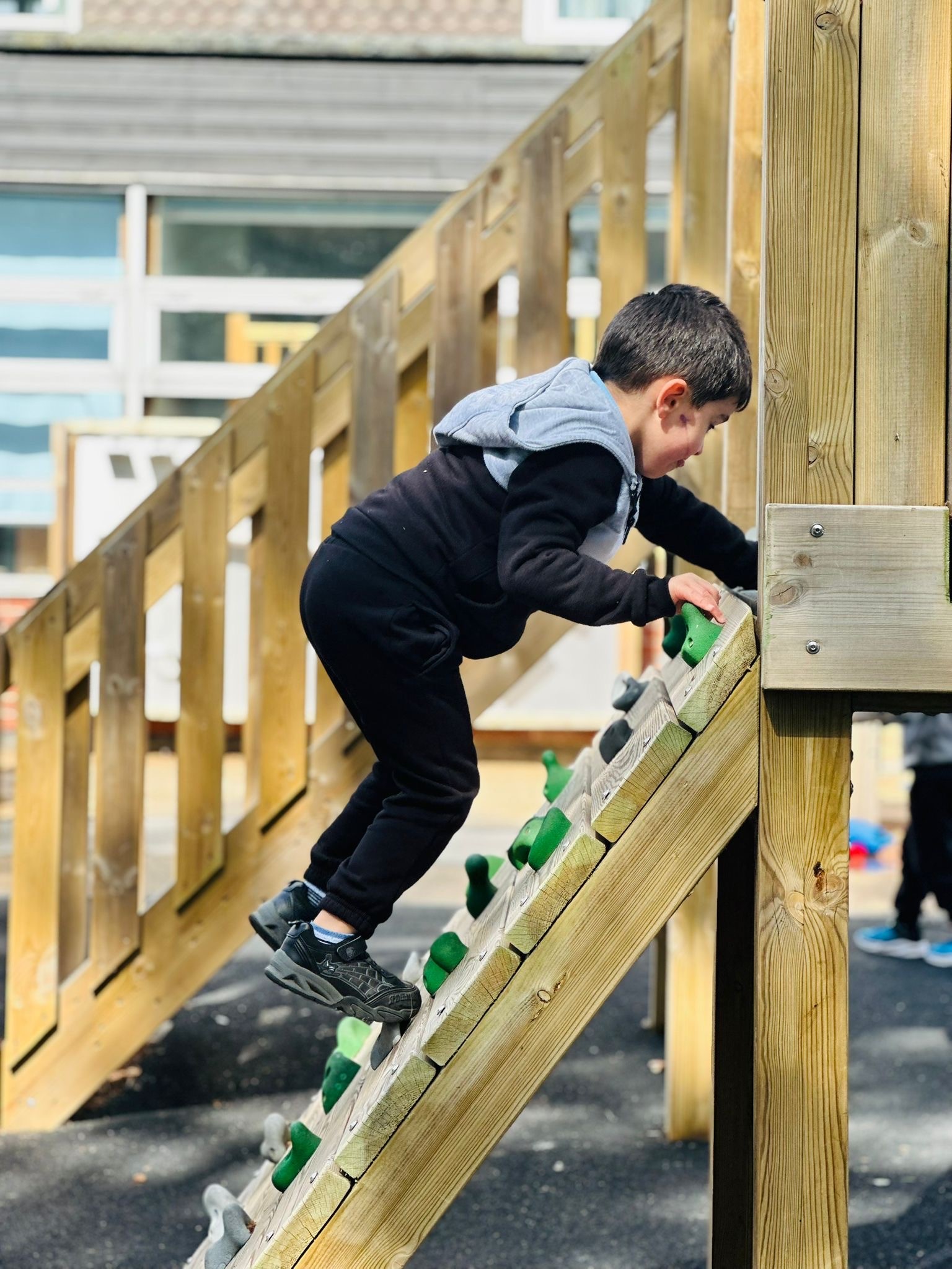 sycamore Nursery child on climbing wall side angle